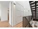 Light-filled hallway with white doors and wood flooring at 4244 E 8Th Pl, Denver, CO 80220