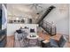 Bright living room with modern staircase, fireplace, sleek furniture, and wood flooring at 4244 E 8Th Pl, Denver, CO 80220