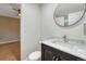 Bathroom with a vanity with marble top and view to a bedroom with a ceiling fan at 123 Wheat Ridge St, Palmer Lake, CO 80133