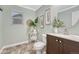 Bright half bathroom with vanity, decor, and natural light at 123 Wheat Ridge St, Palmer Lake, CO 80133