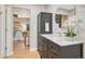 Bathroom with a vanity with marble top and view to a bedroom with a bed and a nightstand at 123 Wheat Ridge St, Palmer Lake, CO 80133