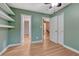 Bedroom with green walls, a ceiling fan, laminate floors and white trim at 123 Wheat Ridge St, Palmer Lake, CO 80133