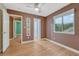 Bedroom with mocha-colored walls, laminate floors, a ceiling fan, and a bright window with tree views at 123 Wheat Ridge St, Palmer Lake, CO 80133