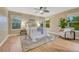 Serene bedroom with neutral decor, ample natural light, and a cozy sitting area for relaxation at 123 Wheat Ridge St, Palmer Lake, CO 80133