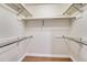 Empty walk-in closet featuring white walls, wood floors and metal racks and bars for storage at 123 Wheat Ridge St, Palmer Lake, CO 80133