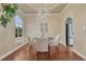 Chic dining room with a modern chandelier, large window, and hardwood floors for elegant gatherings at 123 Wheat Ridge St, Palmer Lake, CO 80133