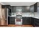 Kitchen with stainless steel appliances, granite countertops, and dark cabinets for a modern look at 123 Wheat Ridge St, Palmer Lake, CO 80133