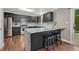 Stylish kitchen with stainless steel appliances, granite countertops, and a convenient breakfast bar at 123 Wheat Ridge St, Palmer Lake, CO 80133