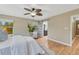 Bedroom features a ceiling fan, and bathroom with a sliding barn door at 123 Wheat Ridge St, Palmer Lake, CO 80133