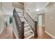 Elegant staircase with dark wood railings and carpeted steps, connecting the home's levels at 123 Wheat Ridge St, Palmer Lake, CO 80133