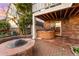 Backyard patio featuring a fire pit, a hot tub, and brick accents providing an outdoor retreat at 23060 Hope Dale Ave, Parker, CO 80138