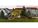 Backyard with a hot tub, fire pit, landscaping, and a fence at 23060 Hope Dale Ave, Parker, CO 80138