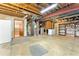 Unfinished basement area with concrete floors, exposed ceiling, and visible utilities, including a washer and dryer at 23060 Hope Dale Ave, Parker, CO 80138