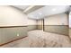Large carpeted basement area with neutral walls and traditional trim, with good ceiling height and light fixtures at 23060 Hope Dale Ave, Parker, CO 80138