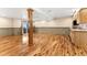 Finished basement featuring wood floors, a support column and a wet bar with wood cabinets and a microwave at 23060 Hope Dale Ave, Parker, CO 80138