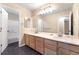 Spacious bathroom with a dual sink vanity with lots of drawers and cabinets and tiled floors at 23060 Hope Dale Ave, Parker, CO 80138