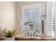 Bright bathroom featuring a granite countertop vanity, modern fixtures, and shuttered windows for natural light at 23060 Hope Dale Ave, Parker, CO 80138