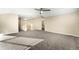 Spacious, carpeted bonus room featuring a ceiling fan and a staircase leading to the upper level at 23060 Hope Dale Ave, Parker, CO 80138