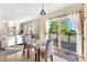 Bright dining area featuring a marble table, plush chairs, and sliding glass doors to the outdoor deck at 23060 Hope Dale Ave, Parker, CO 80138