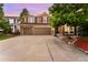 Home's exterior featuring a brick and siding facade, a two-car garage, and landscaping at 23060 Hope Dale Ave, Parker, CO 80138