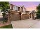 Exterior of a two-story home featuring a two-car garage and brick accents at 23060 Hope Dale Ave, Parker, CO 80138