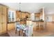 Eat-in kitchen featuring wood cabinets, granite countertops, and modern lighting at 23060 Hope Dale Ave, Parker, CO 80138