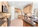 Bright kitchen with stainless steel appliances, wood cabinets, and ample counter space at 23060 Hope Dale Ave, Parker, CO 80138