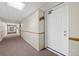 Long, carpeted hallway, complete with unit number on door at 14720 E Kentucky Dr # 612, Aurora, CO 80012