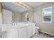 Bathroom features double sink vanity with white cabinets, a large mirror, and wood-look flooring at 5124 S Jebel St, Centennial, CO 80015
