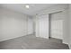 Spacious bedroom boasts neutral walls, plush carpet, and ample storage with sliding closet door and easy access to bathroom at 5124 S Jebel St, Centennial, CO 80015