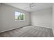 A bright bedroom features neutral walls, plush carpet, and a ceiling fan for added comfort at 5124 S Jebel St, Centennial, CO 80015