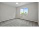 Inviting bedroom features a neutral palette, plush carpet, and a sunlit window at 5124 S Jebel St, Centennial, CO 80015