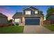 Charming two-story home featuring a blue exterior, brick accents, and a well-maintained front yard at 5124 S Jebel St, Centennial, CO 80015
