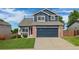 Charming two-story home featuring a blue exterior, brick accents, and a well-maintained front yard at 5124 S Jebel St, Centennial, CO 80015