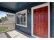 Inviting front porch featuring a bright red door and a view of the home's exterior at 5124 S Jebel St, Centennial, CO 80015