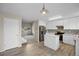 Bright kitchen with island, stainless appliances, and view into the living area and staircase at 5124 S Jebel St, Centennial, CO 80015