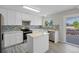 Modern kitchen featuring white cabinetry, stainless steel appliances, and stylish backsplash at 5124 S Jebel St, Centennial, CO 80015