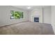 Spacious living room features a large window and a cozy fireplace at 5124 S Jebel St, Centennial, CO 80015
