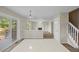Open-concept living area with fireplace, stylish lighting, and access to an outdoor deck at 5124 S Jebel St, Centennial, CO 80015