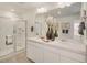 Double vanity bathroom with a large mirror and walk-in shower at 17919 Dandy Brush Dr, Parker, CO 80134