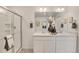 Double vanity bathroom with a large mirror and walk-in shower at 17919 Dandy Brush Dr, Parker, CO 80134