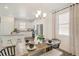 Kitchen and dining area with an island and modern lighting at 17919 Dandy Brush Dr, Parker, CO 80134