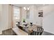 Bright dining room with wood table and bench seating for four at 17919 Dandy Brush Dr, Parker, CO 80134