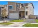 Two-story home with attached garage, stone accents, and front yard at 17919 Dandy Brush Dr, Parker, CO 80134