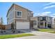 Two story home with attached garage, stone accents, and a nicely landscaped yard at 17919 Dandy Brush Dr, Parker, CO 80134