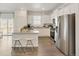 Modern kitchen with white cabinets and granite countertops at 17919 Dandy Brush Dr, Parker, CO 80134