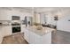 Modern kitchen island with granite countertop and white cabinets at 17919 Dandy Brush Dr, Parker, CO 80134