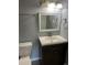 Neutral bathroom with dark cabinets and brushed nickel fixtures at 665 S Clinton St # 14A, Denver, CO 80247