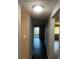 Long hallway with dark wood-look floors leading to patio and rooms at 665 S Clinton St # 14A, Denver, CO 80247