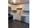 Beautiful updated kitchen features stainless steel appliances, tile backsplash, and neutral color palette at 665 S Clinton St # 14A, Denver, CO 80247